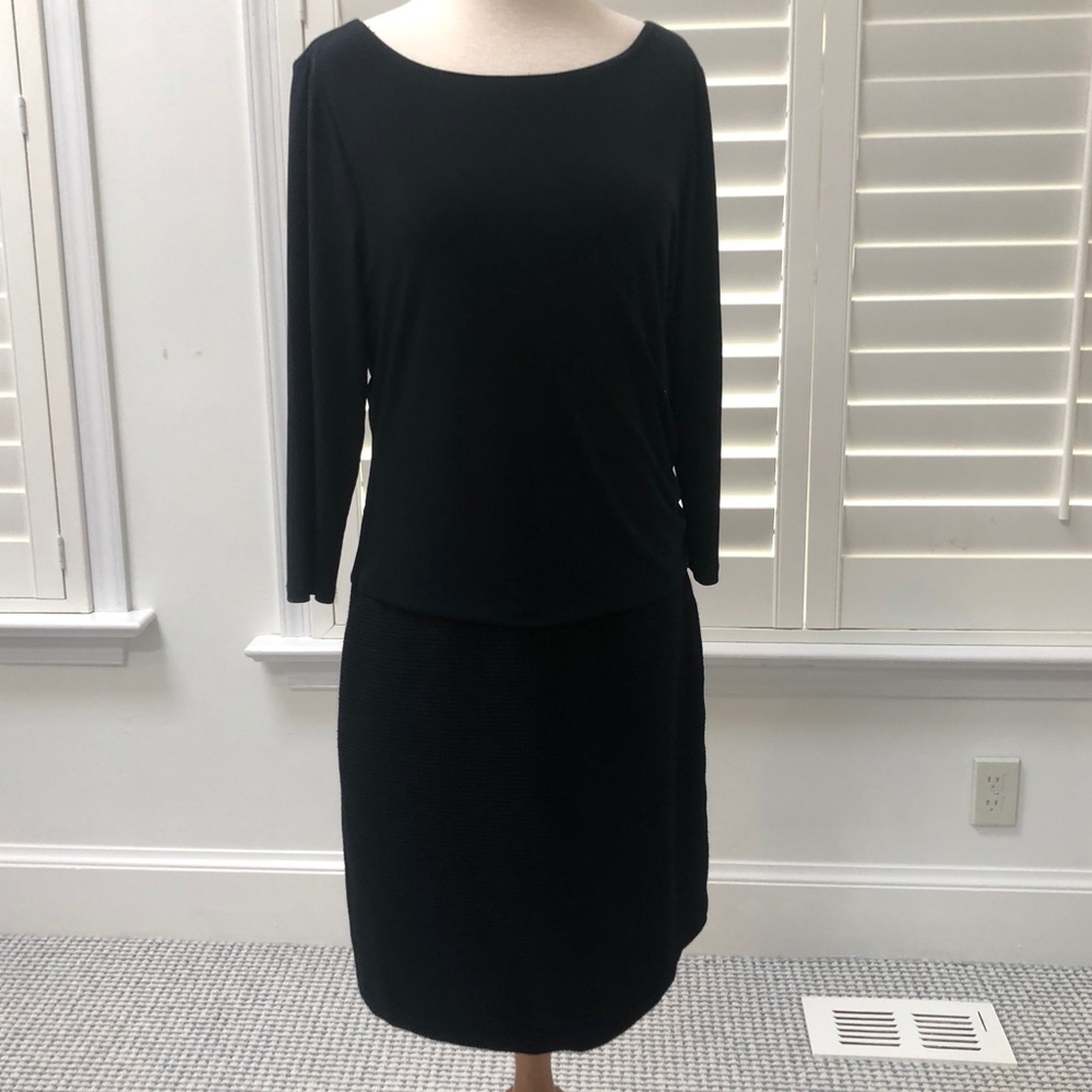 Black dress with jersey top and textured bottom.